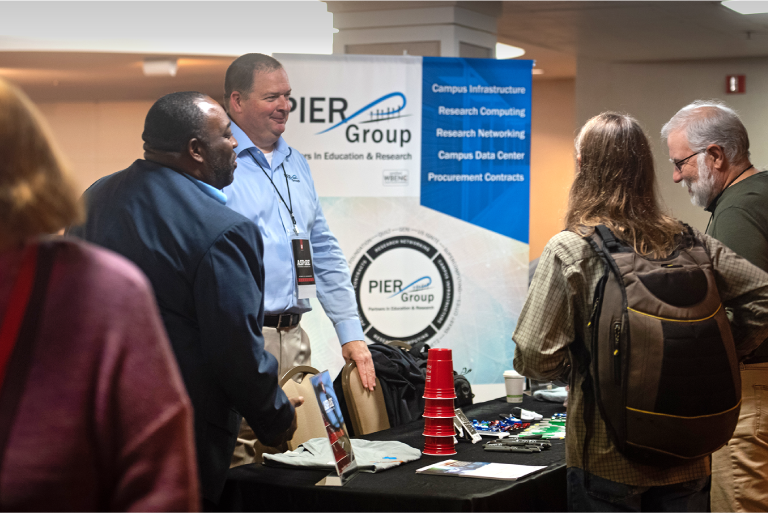 Conference attendees at a vendor table
